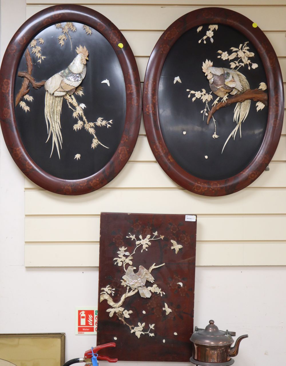 A pair of Meiji Shibayama oval plaques of cockerels on branches, in lacquered frames, overall length 70cm width 52cm, and another panel